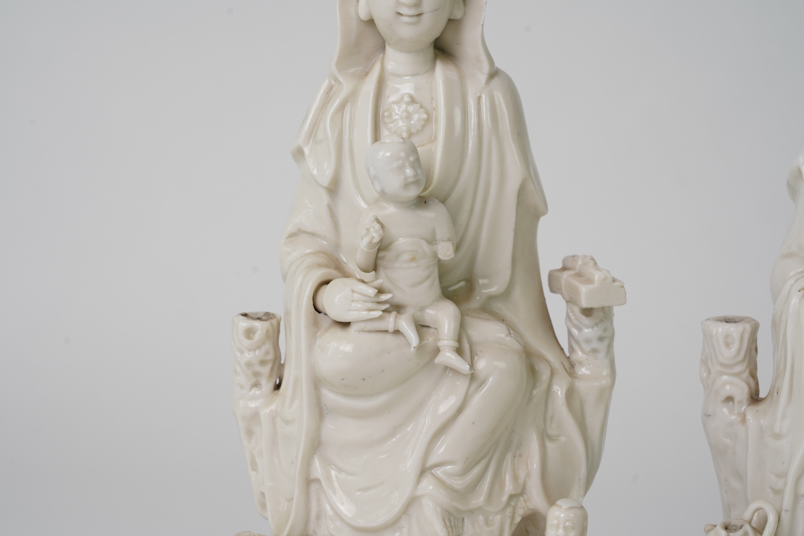 A pair of Chinese blanc de chine groups of Guanyin and children, 18th century